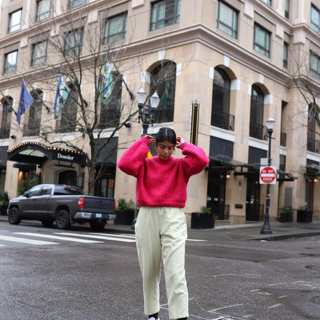 how to bright pink sweater with yellow pants and white sneakers in winter